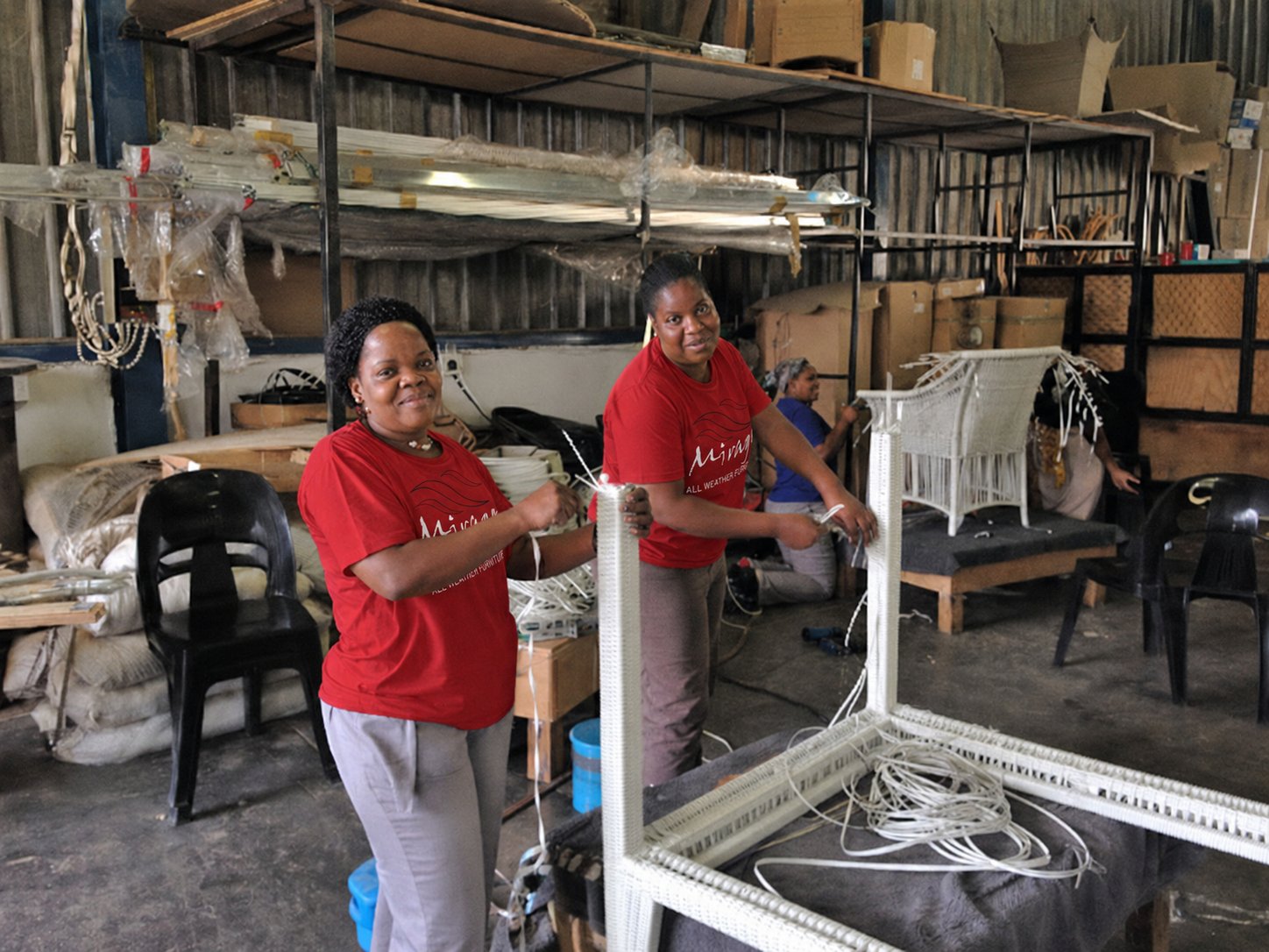 Mirage's weaving team hand-weaving an outdoor table frame in the workshop